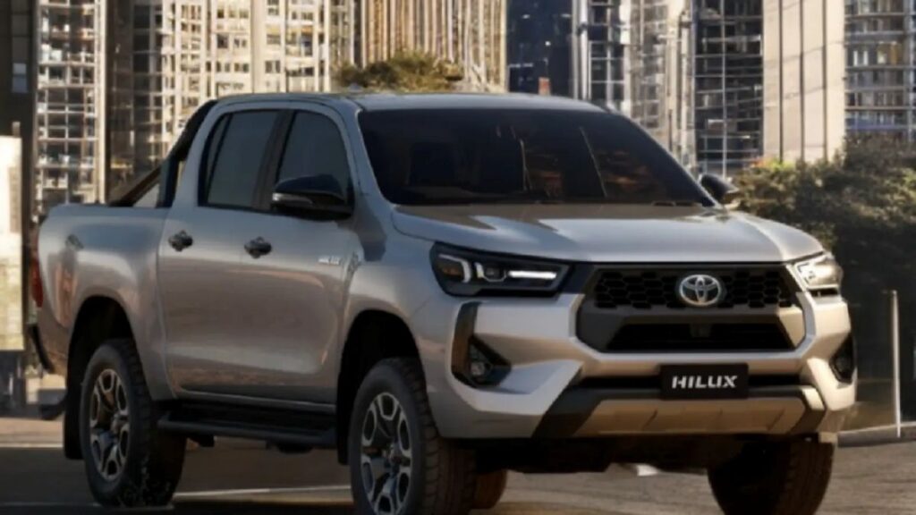 Hilux interior showing touchscreen, climate control, and seat space