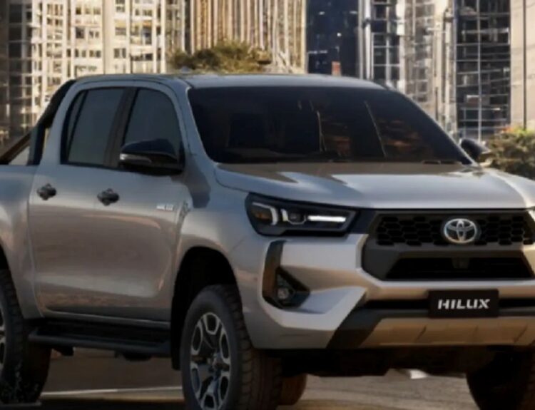 Hilux interior showing touchscreen, climate control, and seat space