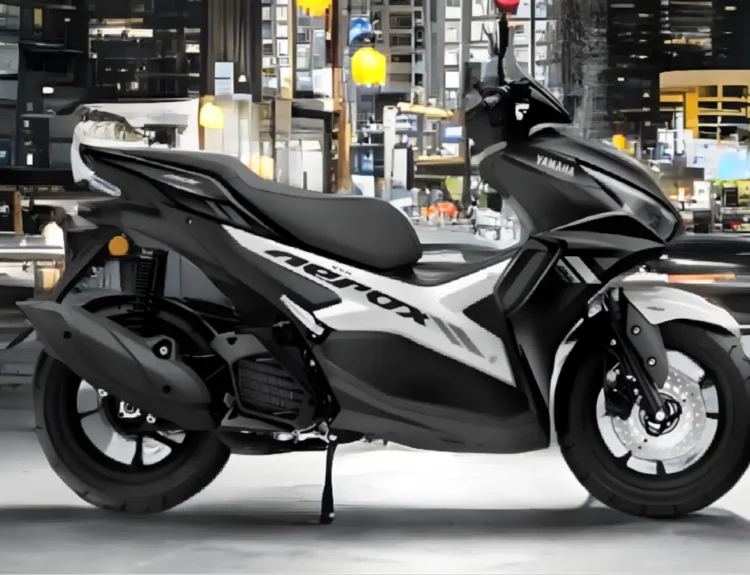 Side view of Yamaha Aerox 155 with rider on urban road